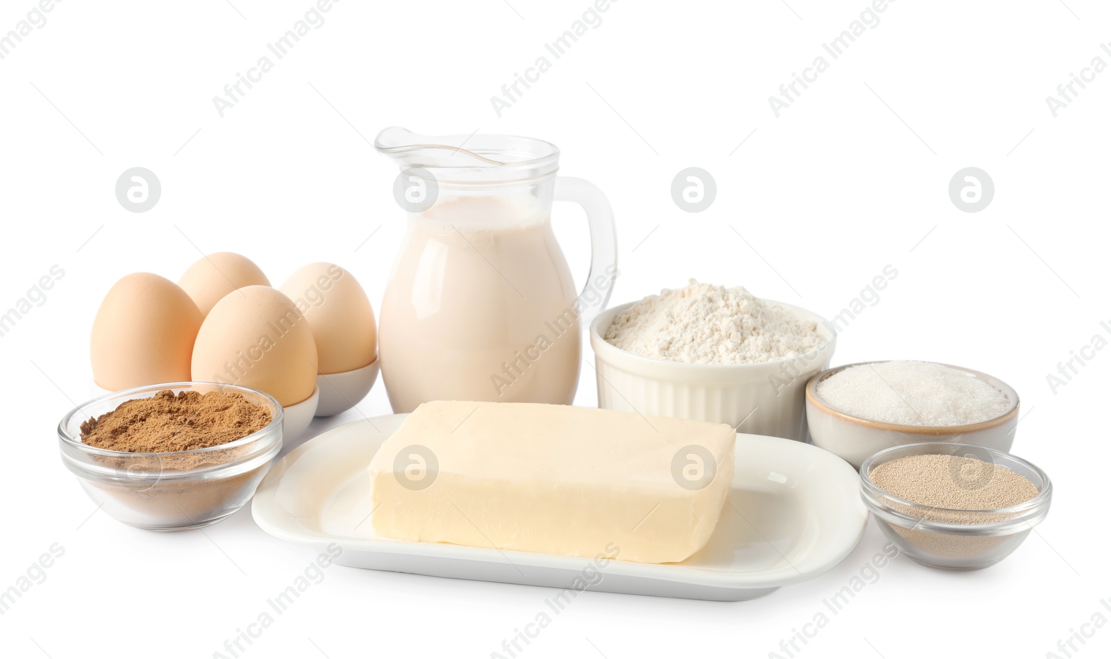 Photo of Making cinnamon rolls. Different ingredients for dough isolated on white