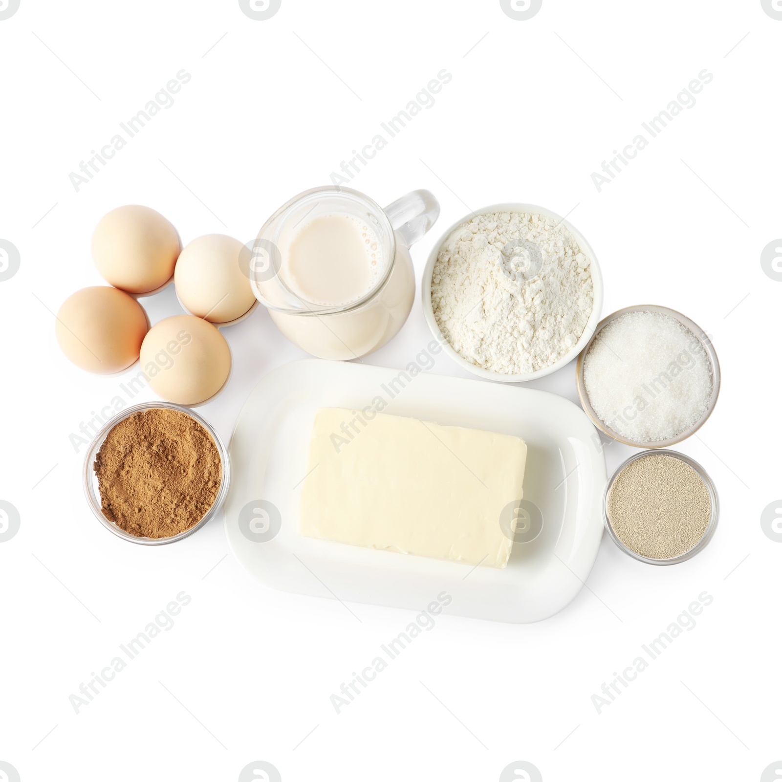 Photo of Making cinnamon rolls. Different ingredients for dough isolated on white, top view