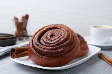 Photo of Delicious cinnamon rolls on grey table, closeup