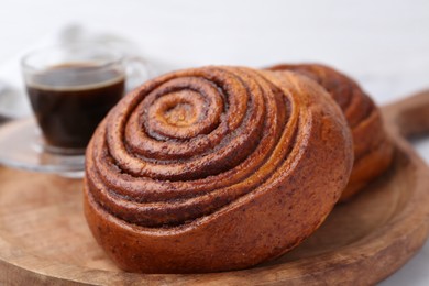 Photo of Delicious cinnamon roll on white table, closeup