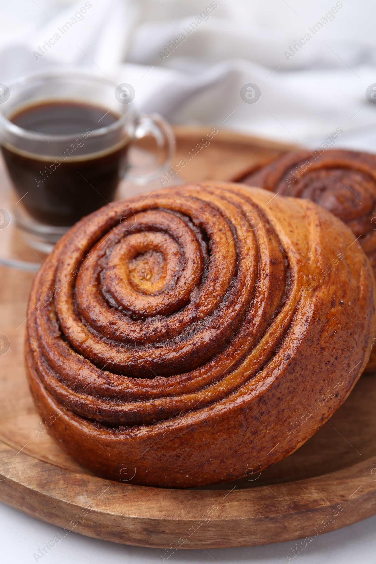 Photo of Delicious cinnamon rolls on white table, closeup