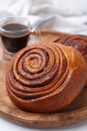 Photo of Delicious cinnamon rolls on white table, closeup