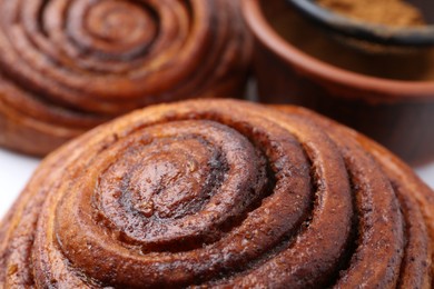 Photo of Tasty cinnamon roll buns as background, closeup