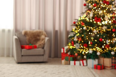 Photo of Blurred view of beautifully decorated Christmas tree in room. Festive interior design