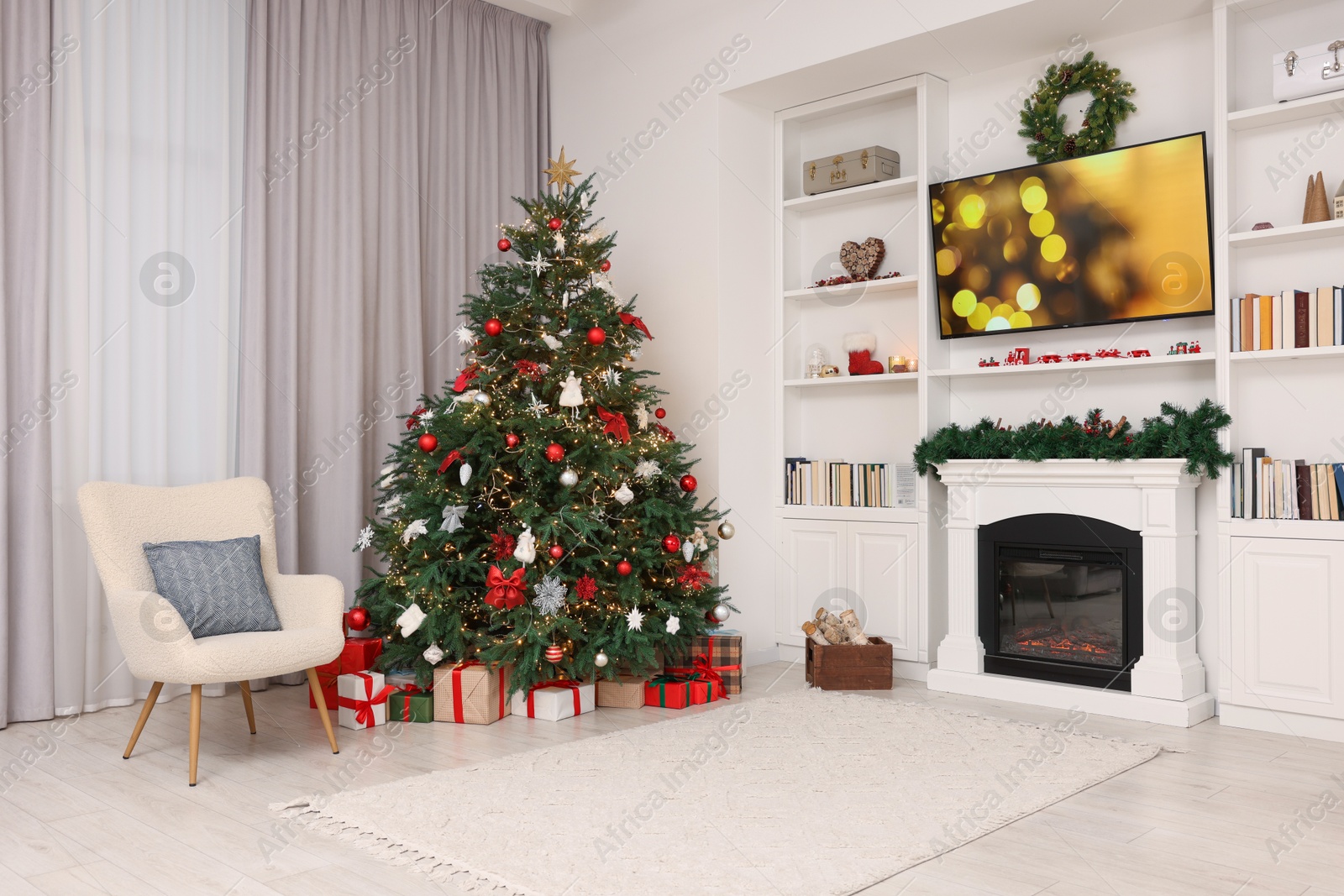 Photo of Beautifully decorated Christmas tree near fireplace in room. Festive interior design