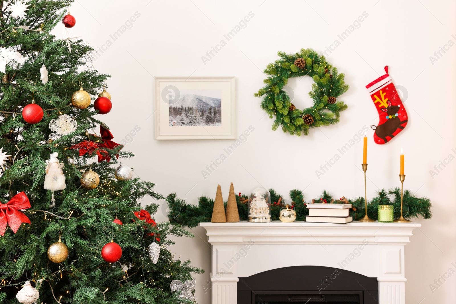 Photo of Decorated Christmas tree and fireplace in room. Festive interior design