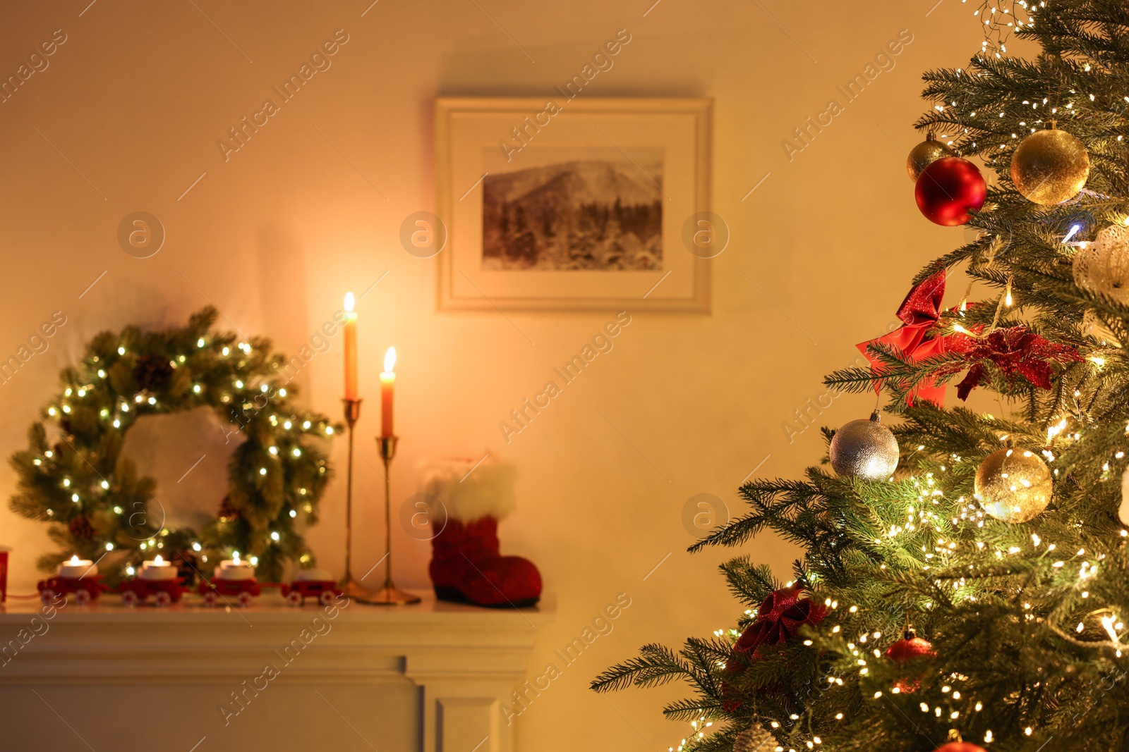 Photo of Decorated fireplace and Christmas tree in room, selective focus. Festive interior design