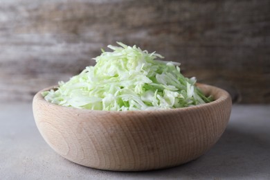 Photo of Fresh shredded cabbage on light table, closeup