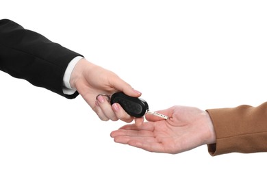 Photo of Dealer giving car key to customer on white background, closeup. Buying auto