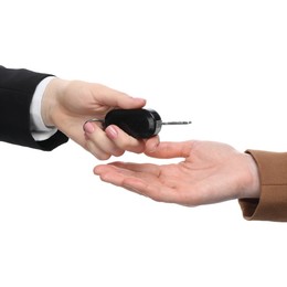 Dealer giving car key to customer on white background, closeup. Buying auto