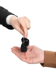 Photo of Dealer giving car keys to customer on white background, closeup. Buying auto