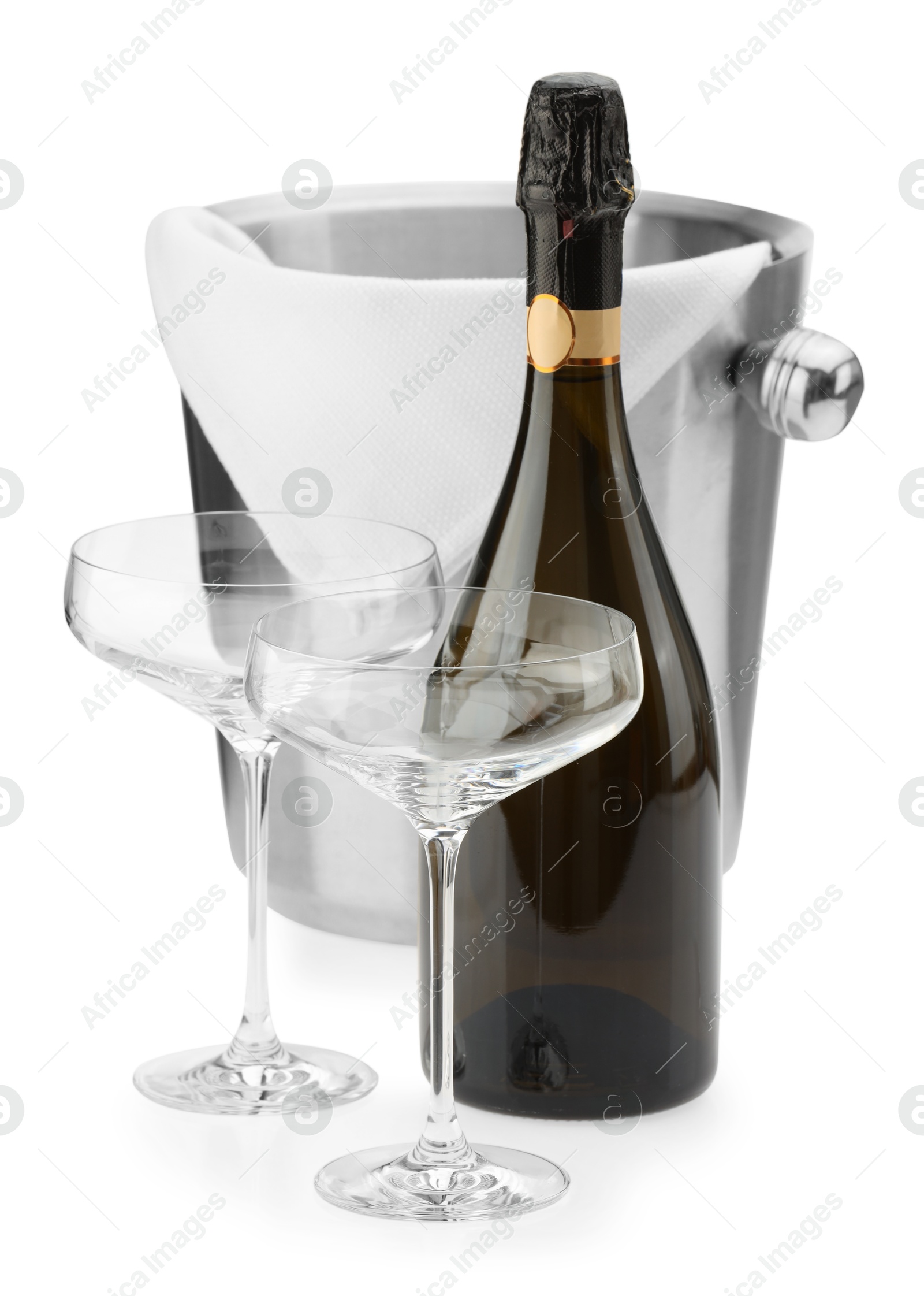 Photo of Bottle of champagne, empty glasses and ice bucket isolated on white