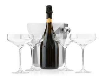 Photo of Bottle of champagne, empty glasses and ice bucket isolated on white