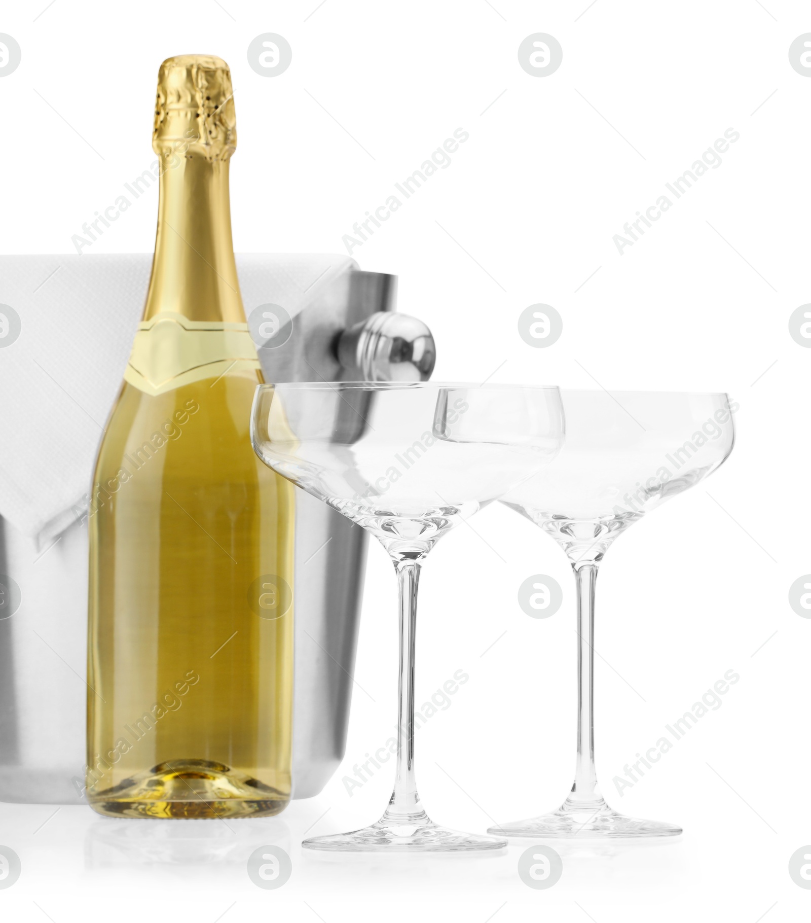 Photo of Bottle of champagne, empty glasses and ice bucket isolated on white