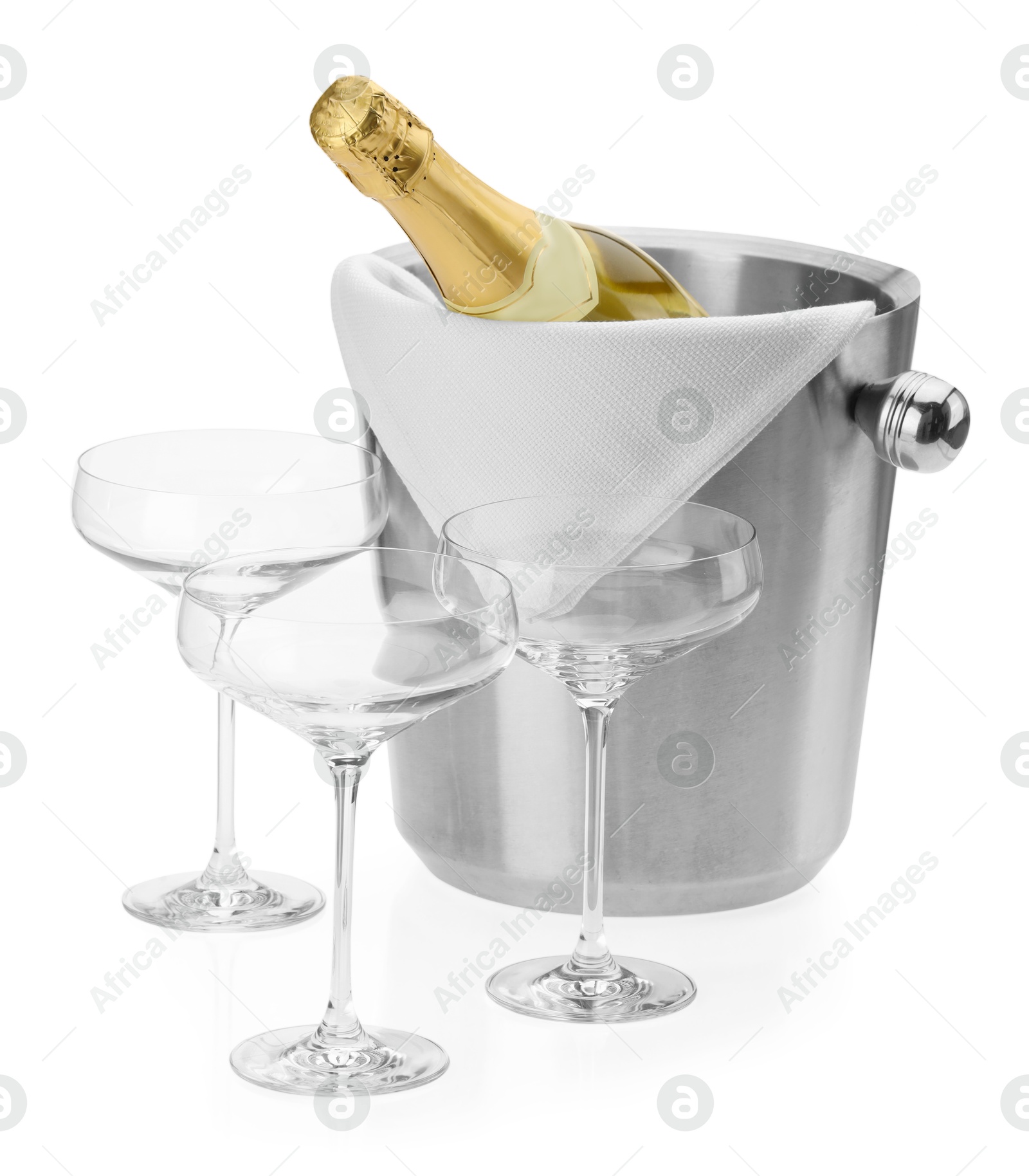 Photo of Bottle of champagne in ice bucket and empty glasses isolated on white