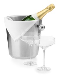 Photo of Bottle of champagne in ice bucket and empty glasses isolated on white