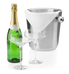 Photo of Bottle of champagne, empty glasses and ice bucket isolated on white