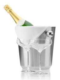 Photo of Bottle of champagne in ice bucket and empty glasses isolated on white