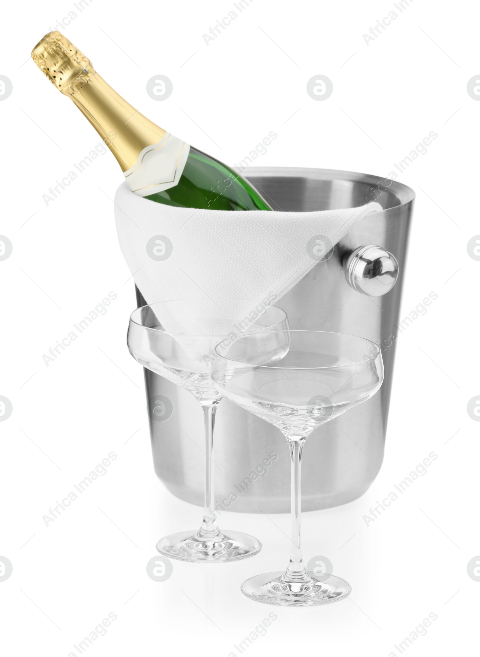 Photo of Bottle of champagne in ice bucket and empty glasses isolated on white