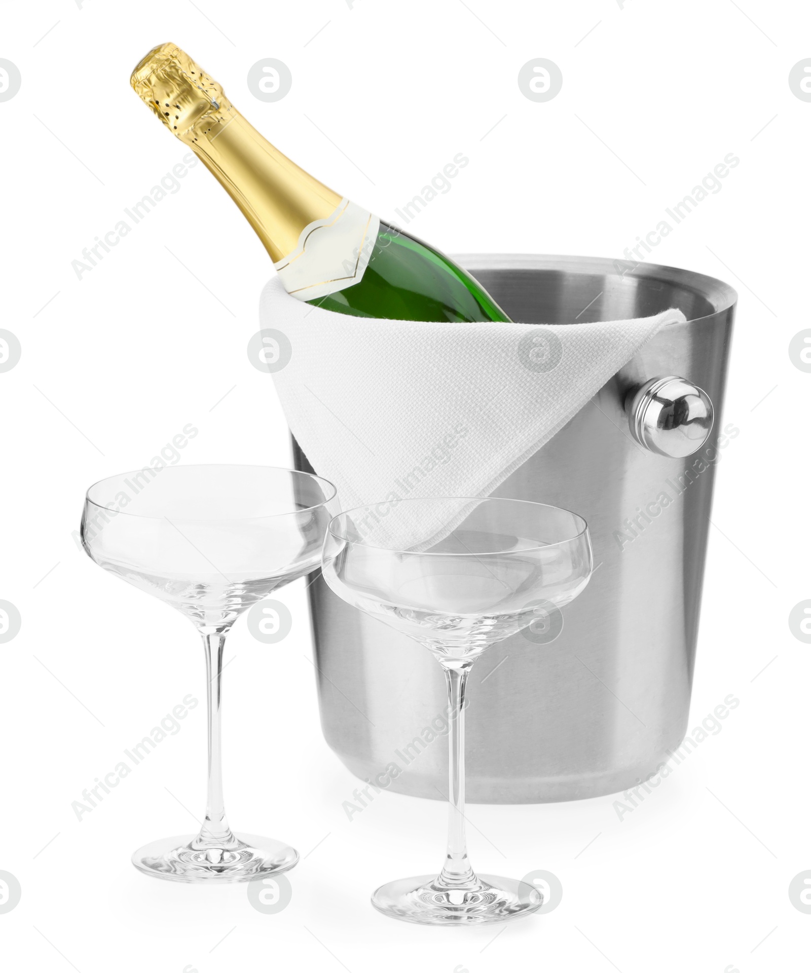 Photo of Bottle of champagne in ice bucket and empty glasses isolated on white