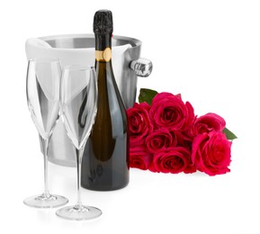 Photo of Bottle of champagne, empty glasses, beautiful roses and ice bucket isolated on white