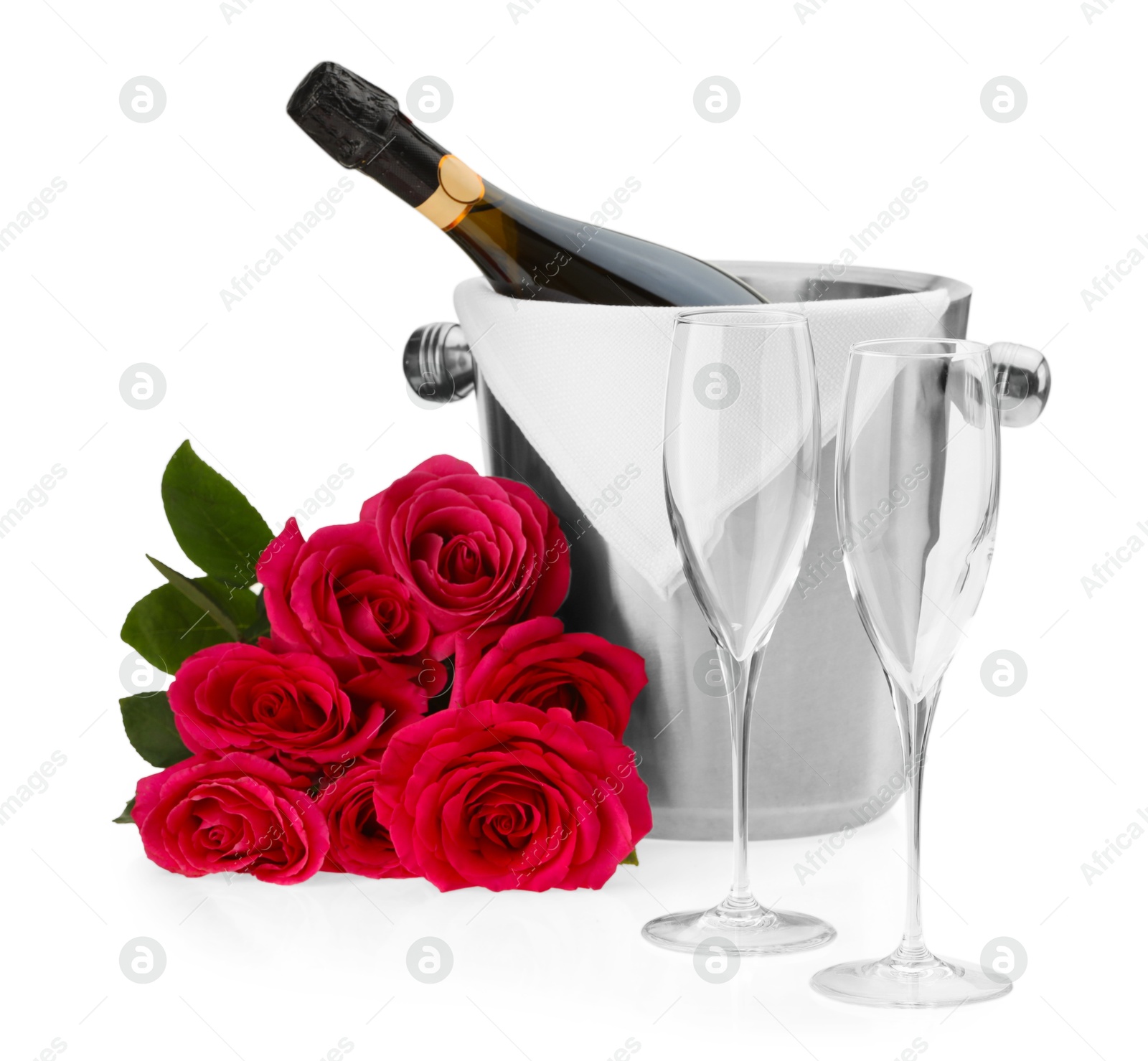 Photo of Bottle of champagne in ice bucket, beautiful roses and empty glasses isolated on white