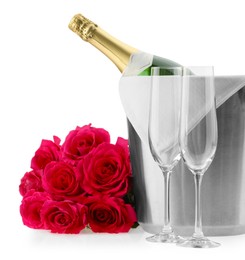 Photo of Bottle of champagne in ice bucket, beautiful roses and empty glasses isolated on white