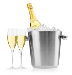 Photo of Champagne in glasses and ice bucket with bottle isolated on white