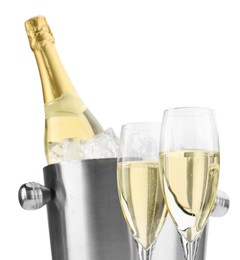 Photo of Champagne in glasses and ice bucket with bottle isolated on white