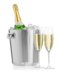 Photo of Champagne in glasses and ice bucket with bottle isolated on white