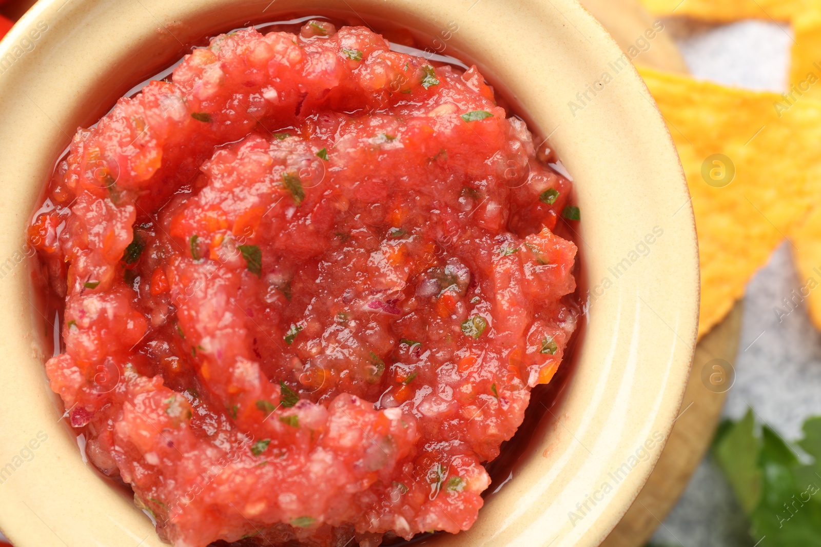 Photo of Spicy salsa in bowl on table, top view