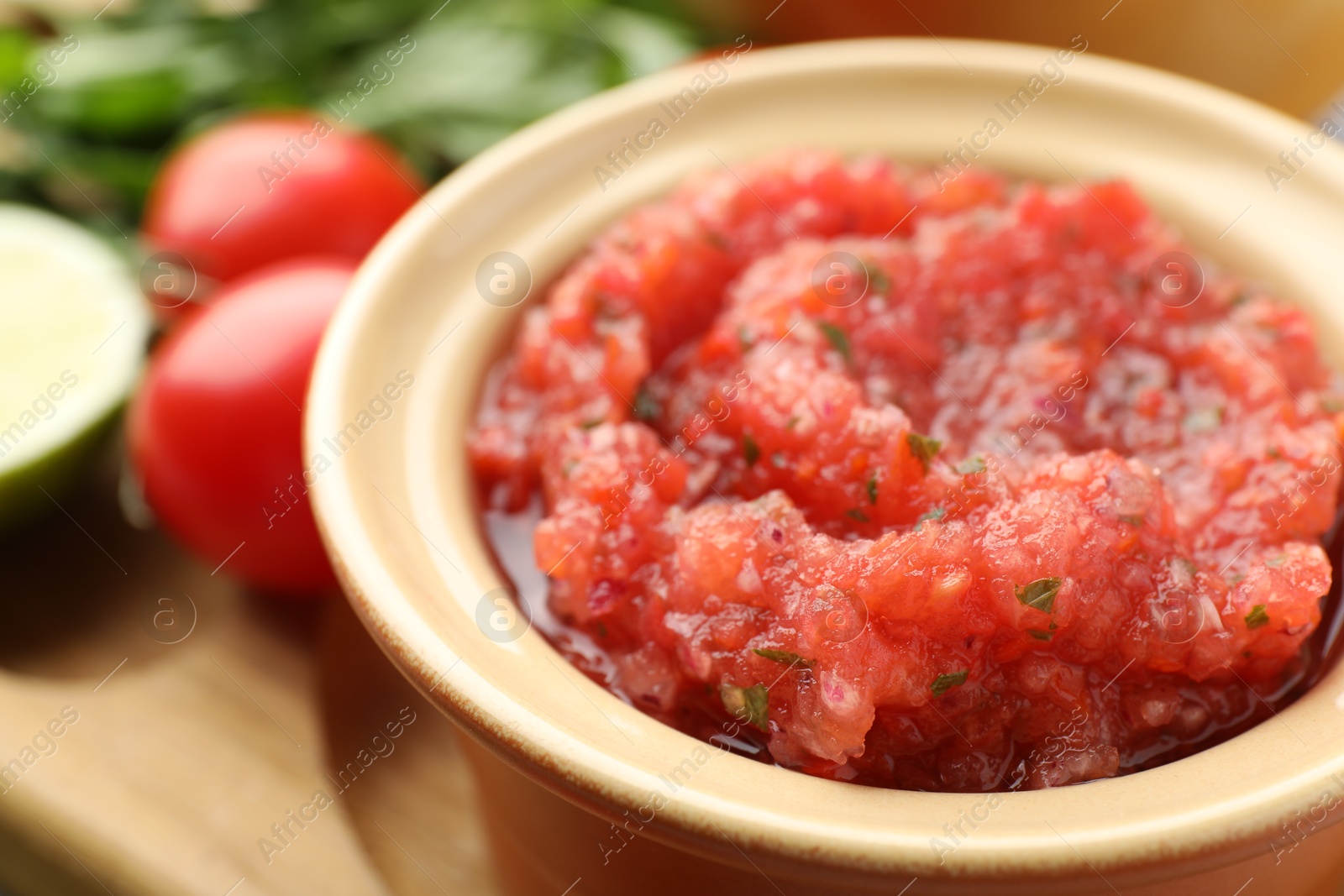 Photo of Spicy salsa in bowl on table, closeup