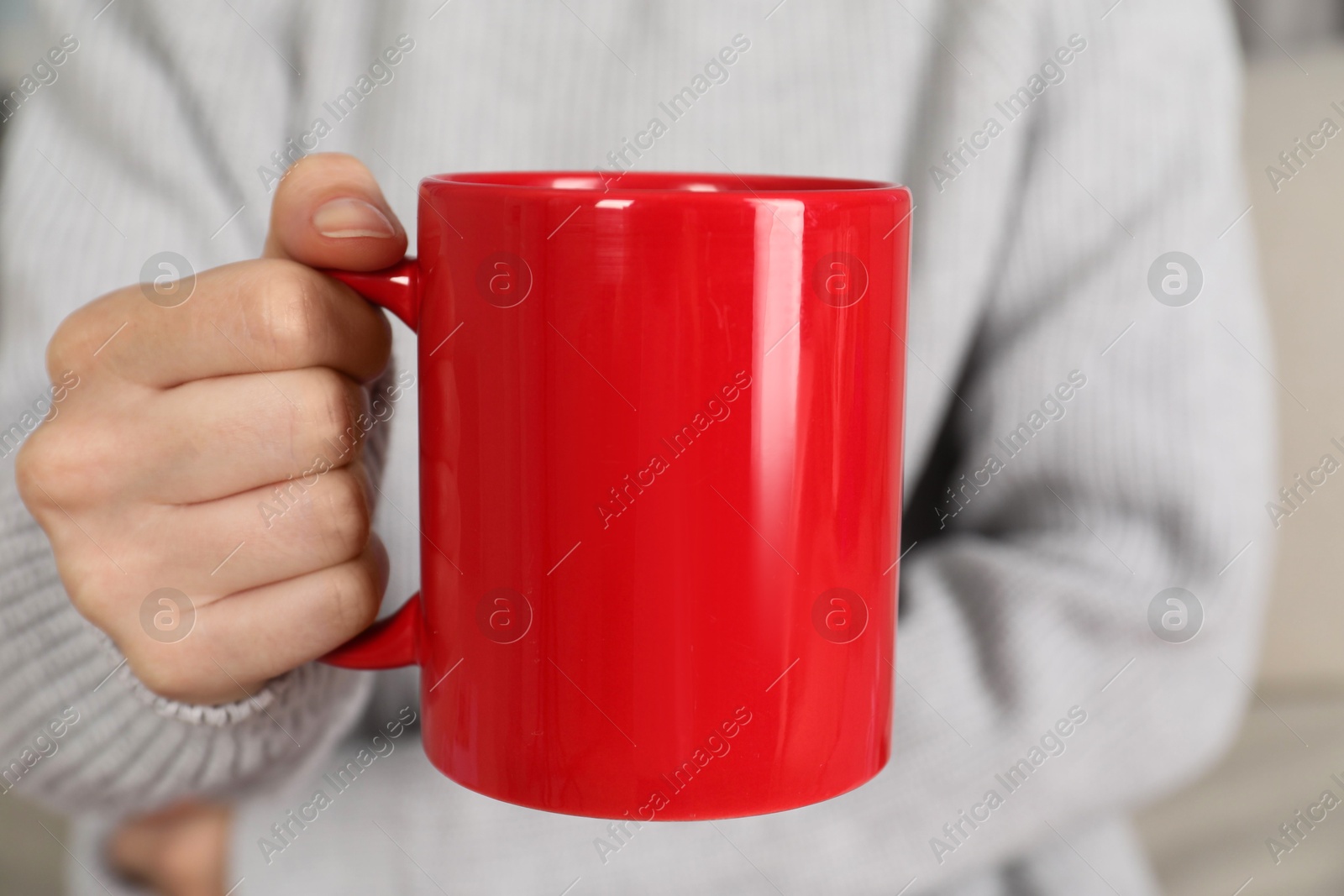 Photo of Woman with red ceramic cup, closeup. Mockup for design