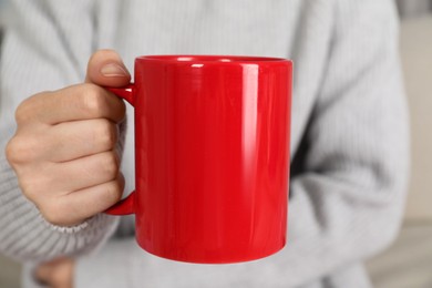 Photo of Woman with red ceramic cup, closeup. Mockup for design