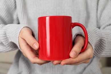 Photo of Woman with red ceramic cup, closeup. Mockup for design