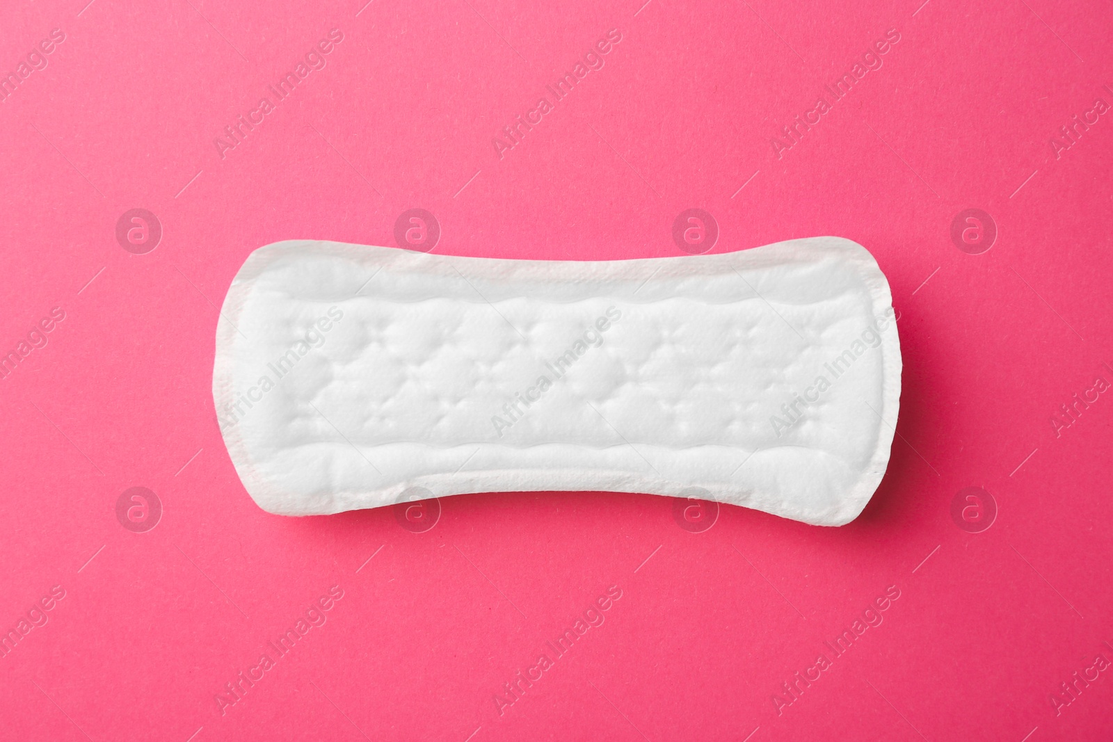 Photo of Menstrual pad on pink background, top view