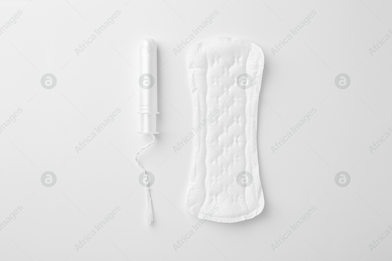 Photo of Menstrual pad and tampon on white background, top view