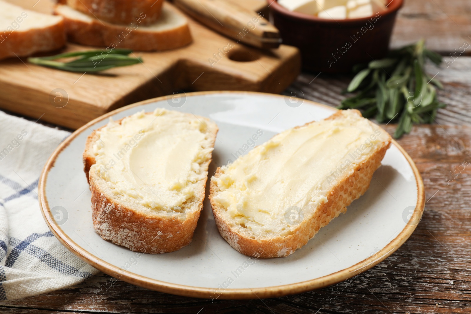 Fresh bread with butter on wooden table, closeup Photo of Fresh bread with butter on wooden table, closeup