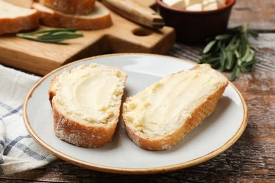Photo of Fresh bread with butter on wooden table, closeup