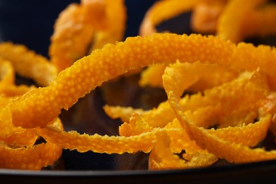 Photo of Pile of fresh orange zest on plate, closeup