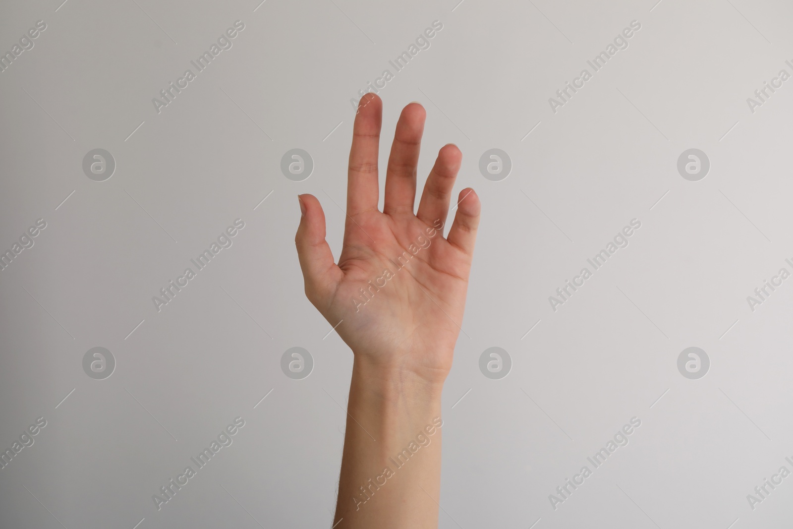 Photo of Woman with visible hand veins on light grey background, closeup