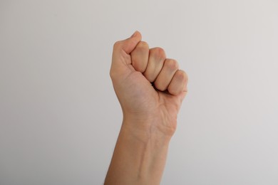 Photo of Woman with visible hand veins on light grey background, closeup