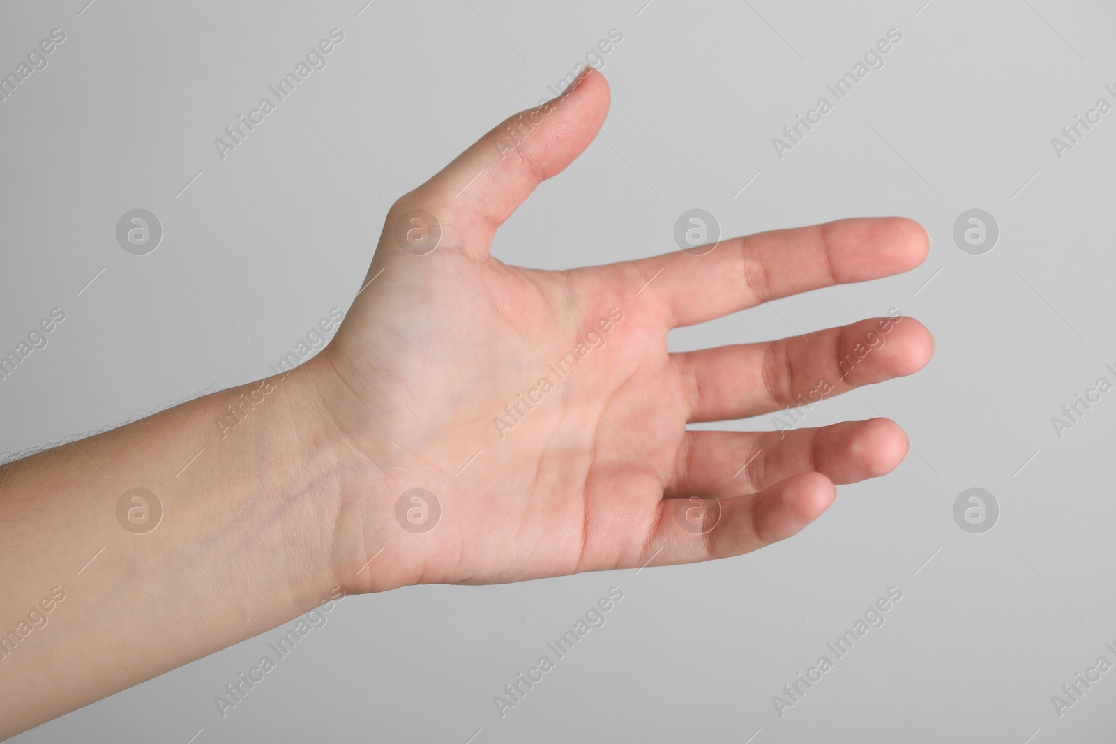 Photo of Woman with visible hand veins on light grey background, closeup