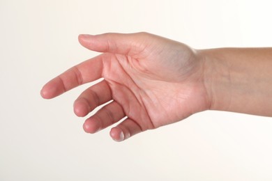 Photo of Woman with visible hand veins on white background, closeup