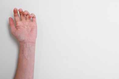 Photo of Woman with visible hand veins on white background, closeup. Space for text