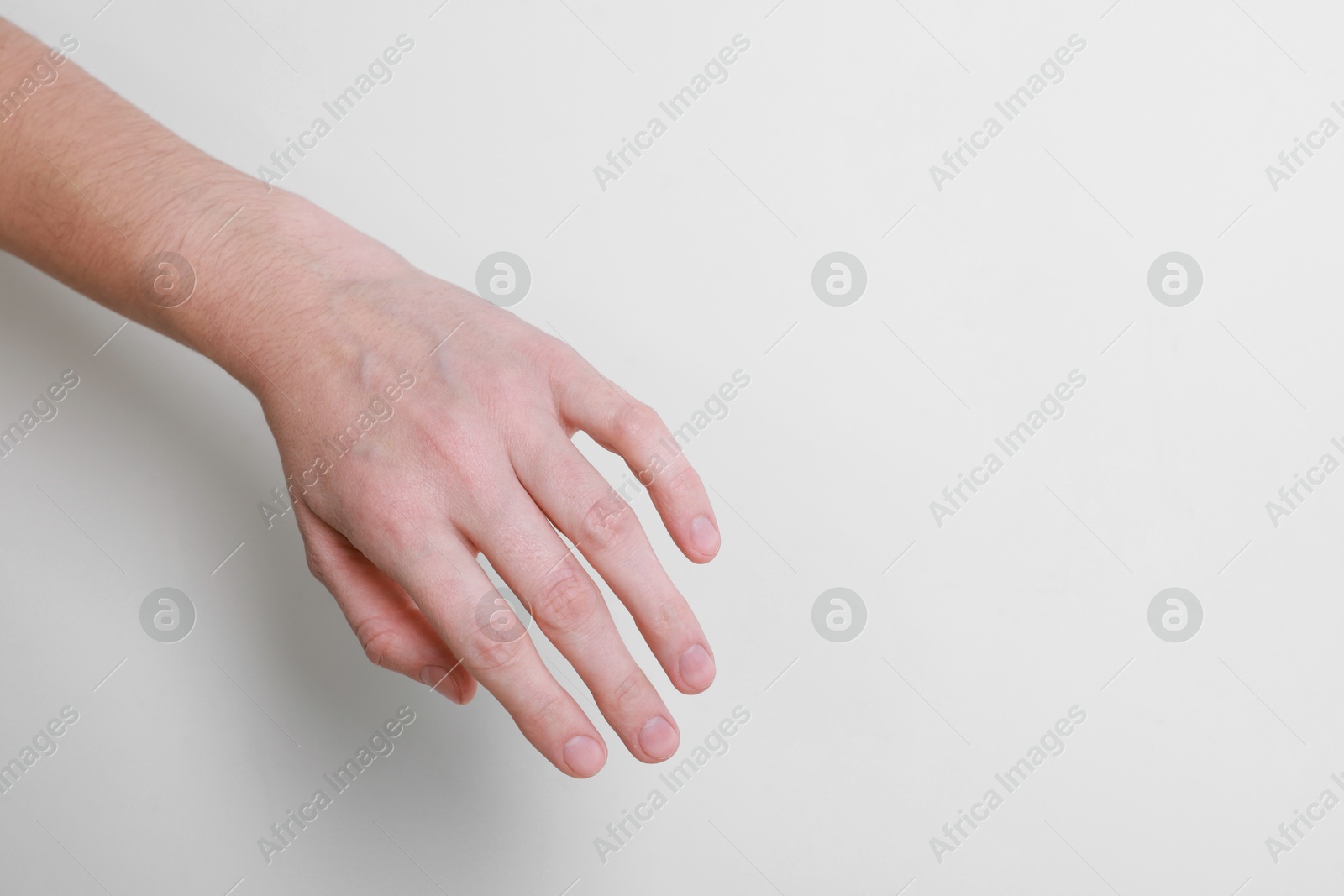 Photo of Woman with visible hand veins on white background, closeup. Space for text