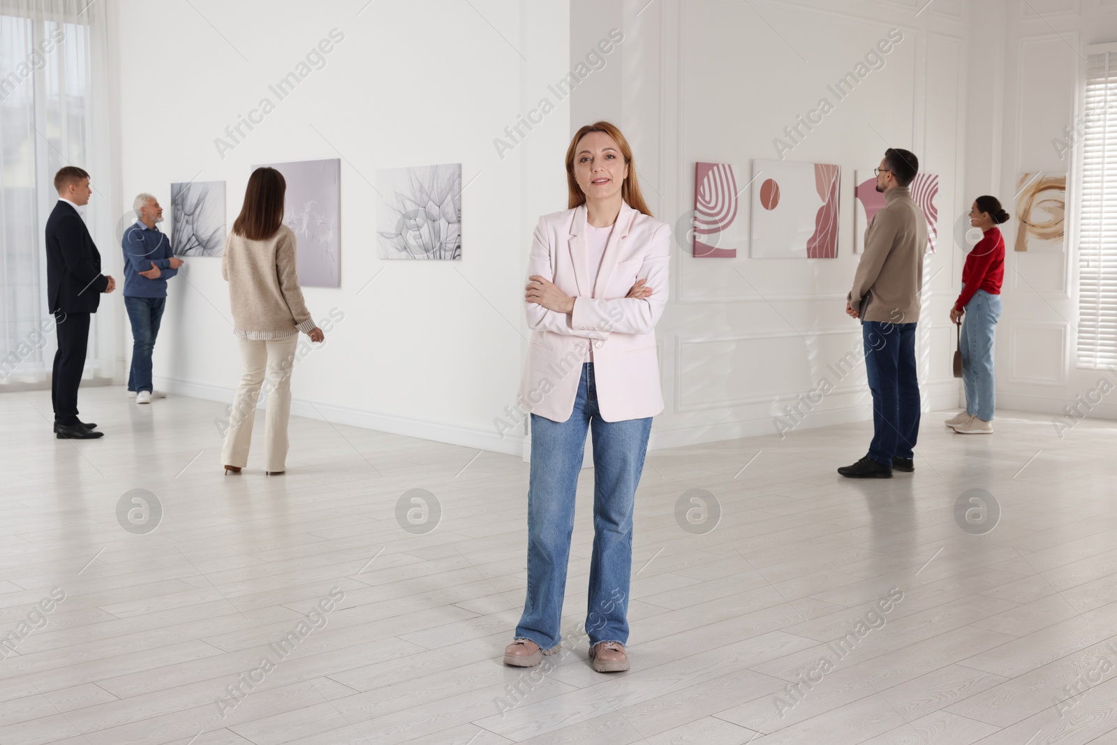 Photo of Beautiful woman enjoying art in modern gallery