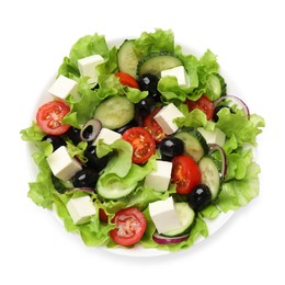 Photo of Delicious fresh Greek salad isolated on white, top view