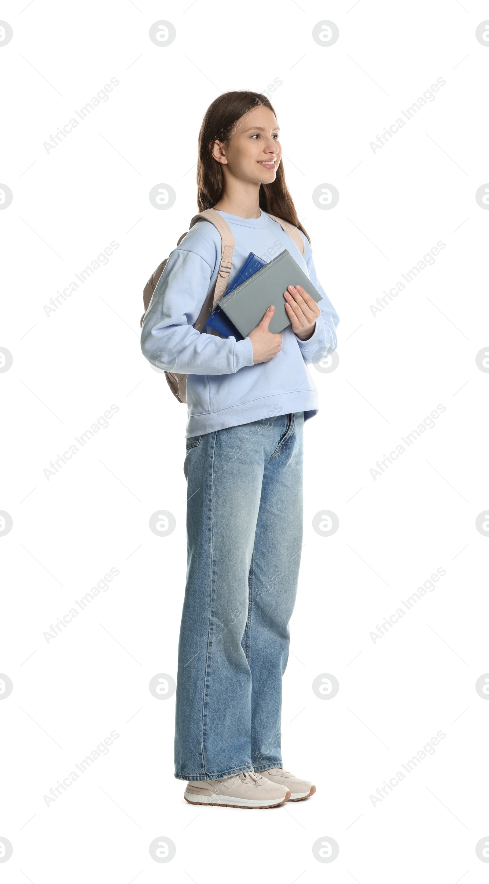 Photo of Smiling teenage girl with books on white background