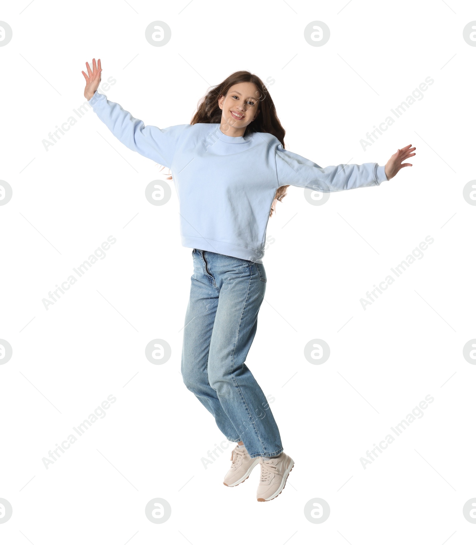 Photo of Smiling teenage girl jumping on white background